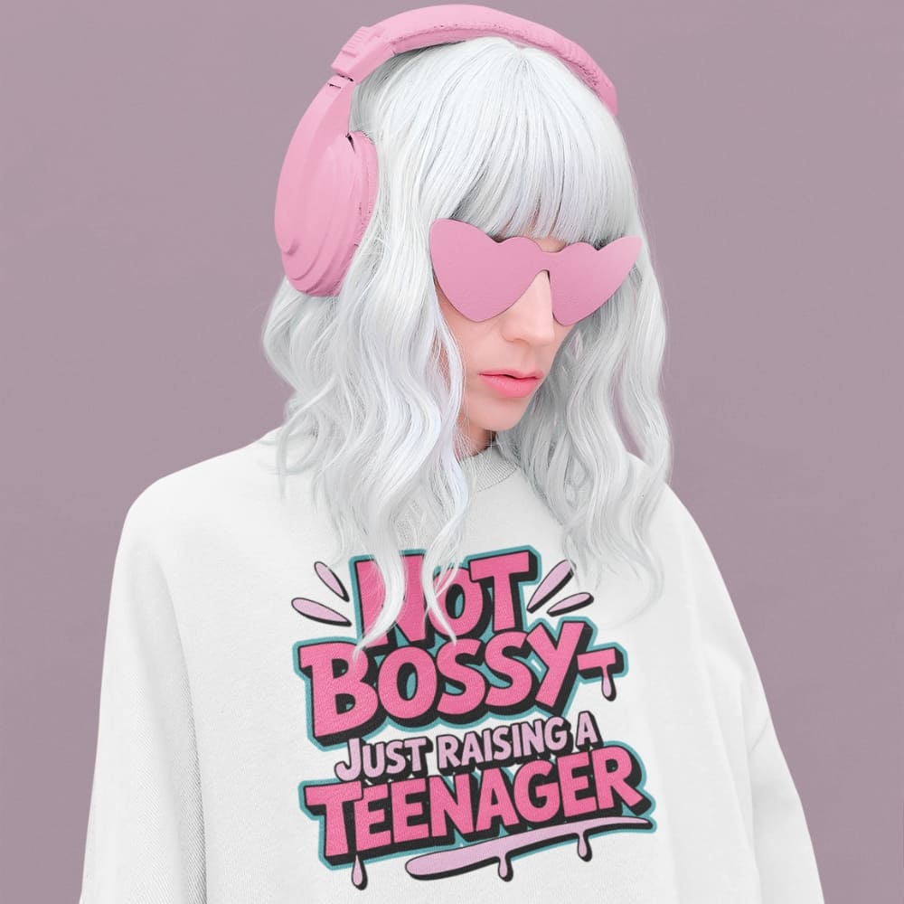 Person wearing pink heart-shaped sunglasses, pink earmuffs, and a white sweatshirt with text on a purple background