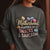 Sweatshirt design with text “Motherhood. Powered by Snacks & Sarcasm.” featuring colorful macarons and a steaming coffee cup on vintage-washed cotton fleece.