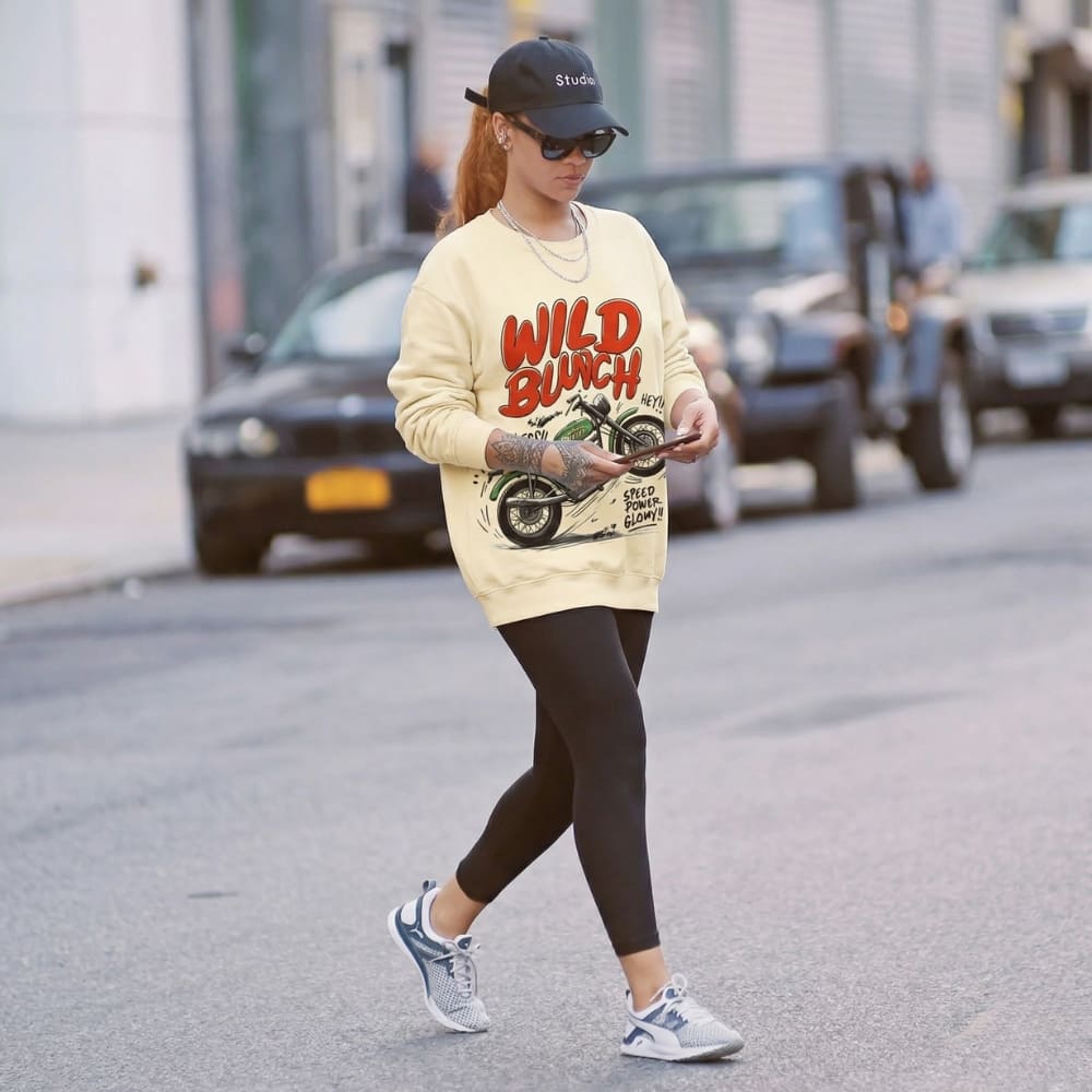 Person wearing a 'Wild Bunch' sweatshirt walking on a street.