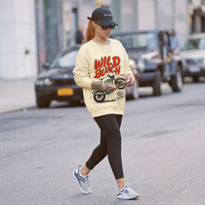 Person wearing a 'Wild Bunch' sweatshirt walking on a street.