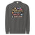 Sweatshirt design with text “Motherhood. Powered by Snacks & Sarcasm.” featuring colorful macarons and a steaming coffee cup on vintage-washed cotton fleece.