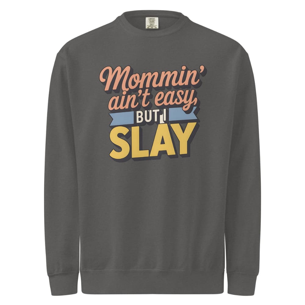 “Mommin' Ain’t Easy But I Slay” retro-style DTG printed design in peach, blue, and yellow on vintage garment-dyed fleece sweatshirt
