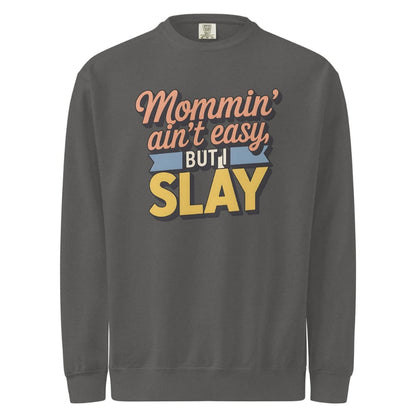 “Mommin' Ain’t Easy But I Slay” retro-style DTG printed design in peach, blue, and yellow on vintage garment-dyed fleece sweatshirt