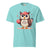 Cute cartoon owl cheerleader holding a pom-pom and clipboard, wearing a red cap with the quote “Behind Every Great Swing Is a Loud Mom” – featured on garment-dyed heavyweight cotton tee