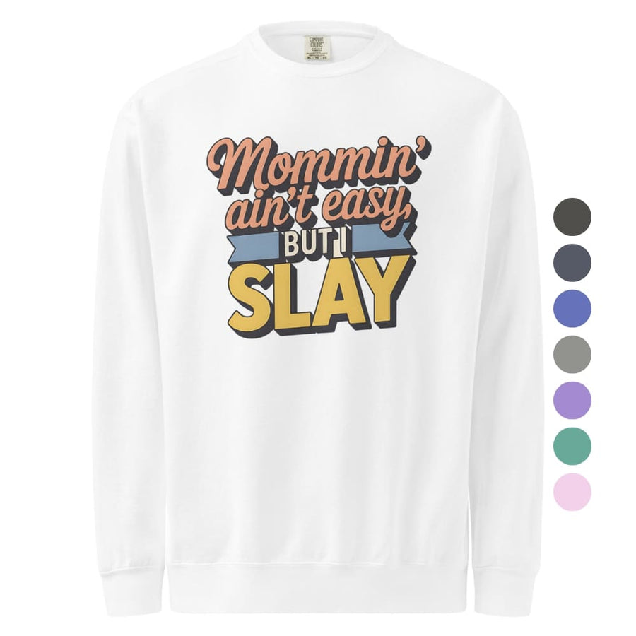 “Mommin' Ain’t Easy But I Slay” retro-style DTG printed design in peach, blue, and yellow on vintage garment-dyed fleece sweatshirt