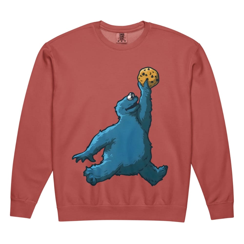 Red sweatshirt with a blue monster holding a cookie on a white background