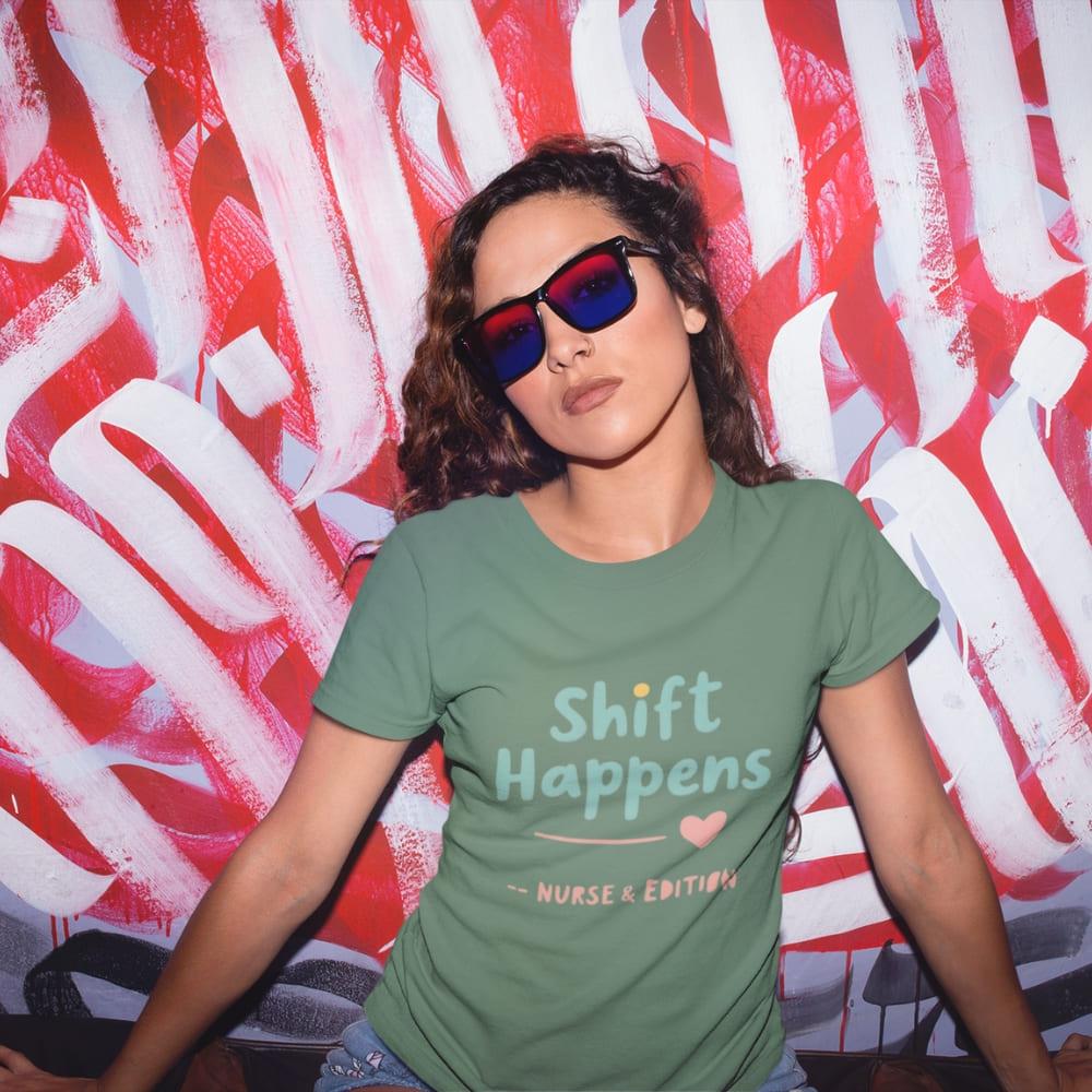 “Shift Happens – Nurse Edition” pastel text design printed on a thick garment-dyed cotton t-shirt, perfect for nurses and healthcare professionals with a sense of humor.