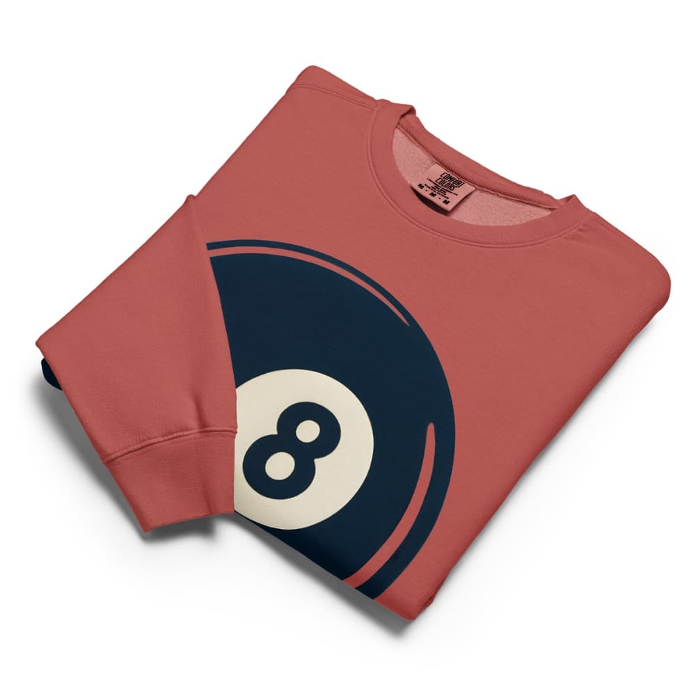 Folded red sweatshirt with an 8-ball design on a white background