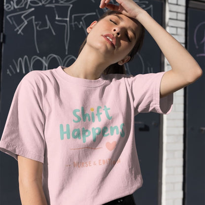 “Shift Happens – Nurse Edition” pastel text design printed on a thick garment-dyed cotton t-shirt, perfect for nurses and healthcare professionals with a sense of humor.