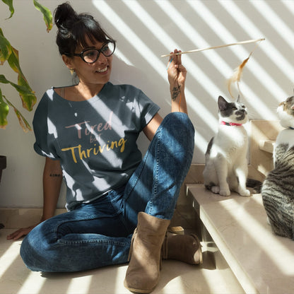 Garment-dyed relaxed fit t-shirt with motivational quote “Tired But Thriving” in modern handwritten script