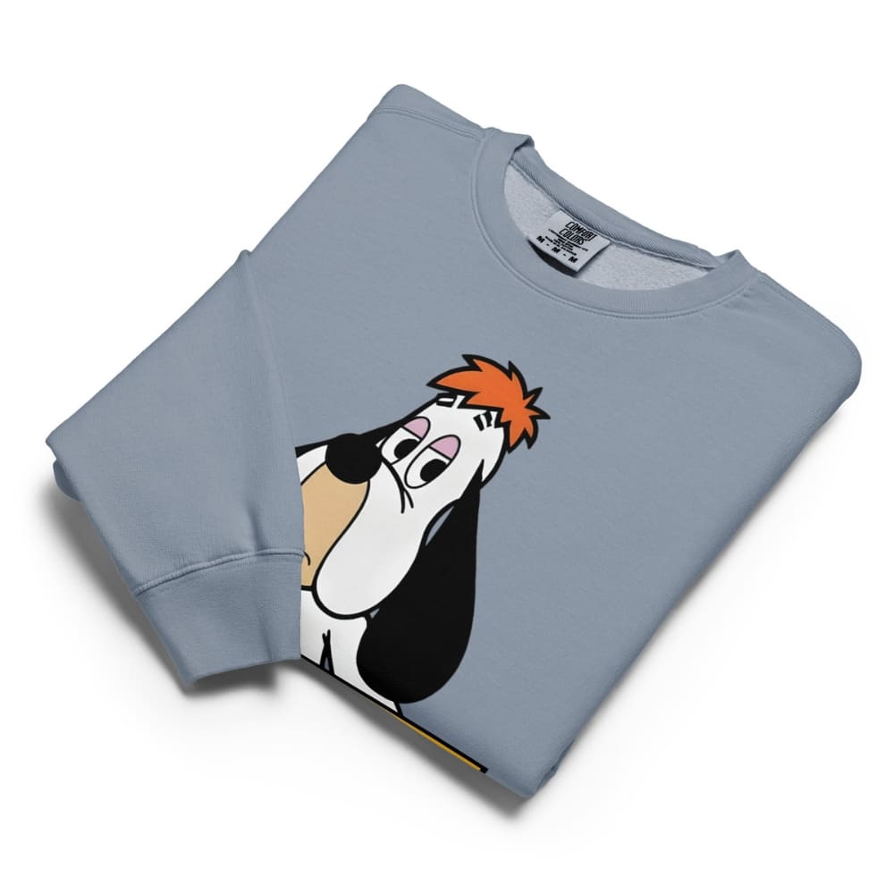 Folded blue sweatshirt with cartoon character design on a white background