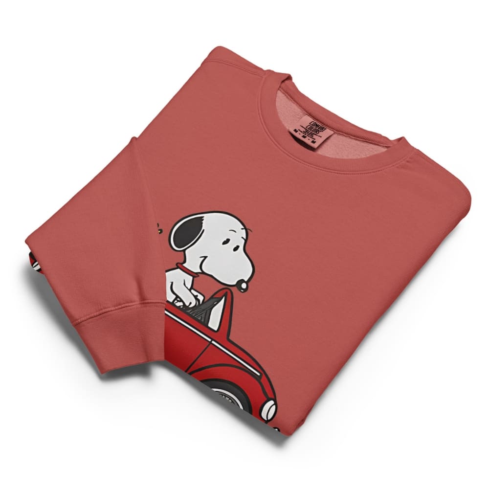 Folded red sweatshirt with a cartoon dog design on a white background