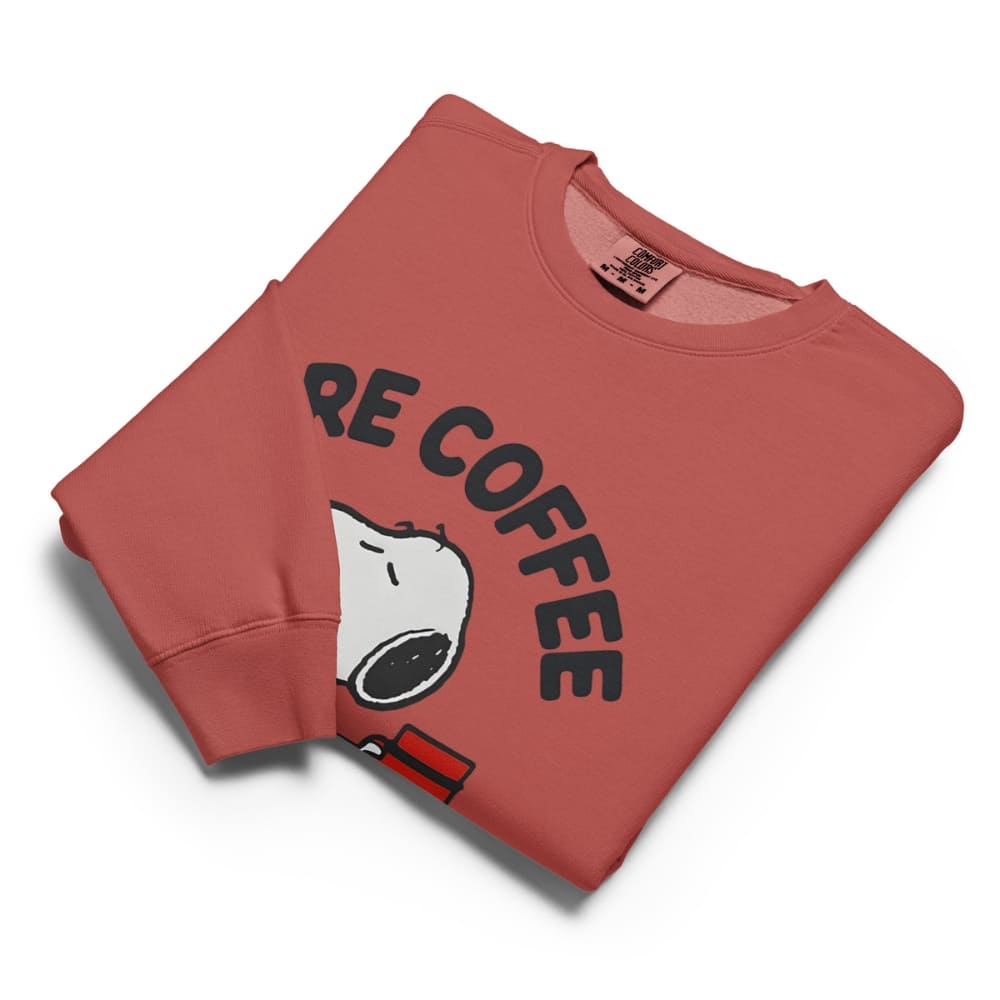 Folded red sweatshirt with 'RE COFFEE' text and cartoon character on a white background