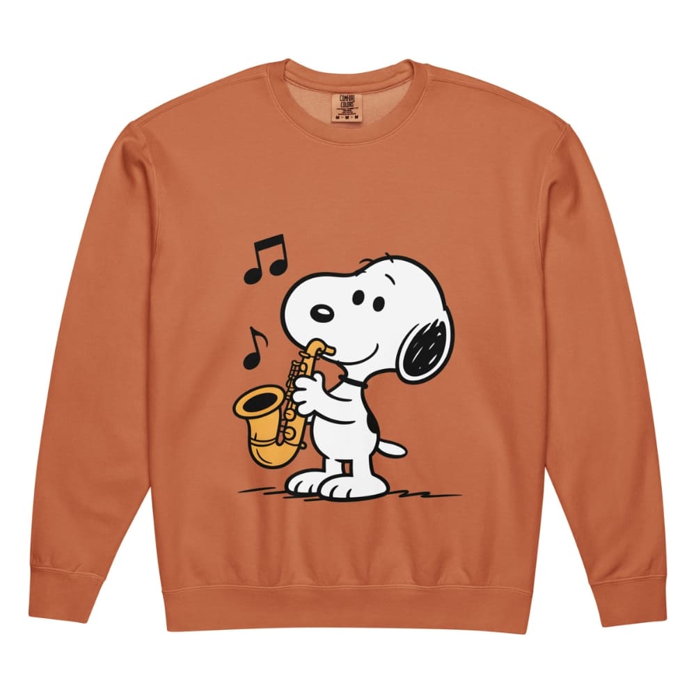 Orange sweatshirt with a cartoon dog playing a saxophone on a white background