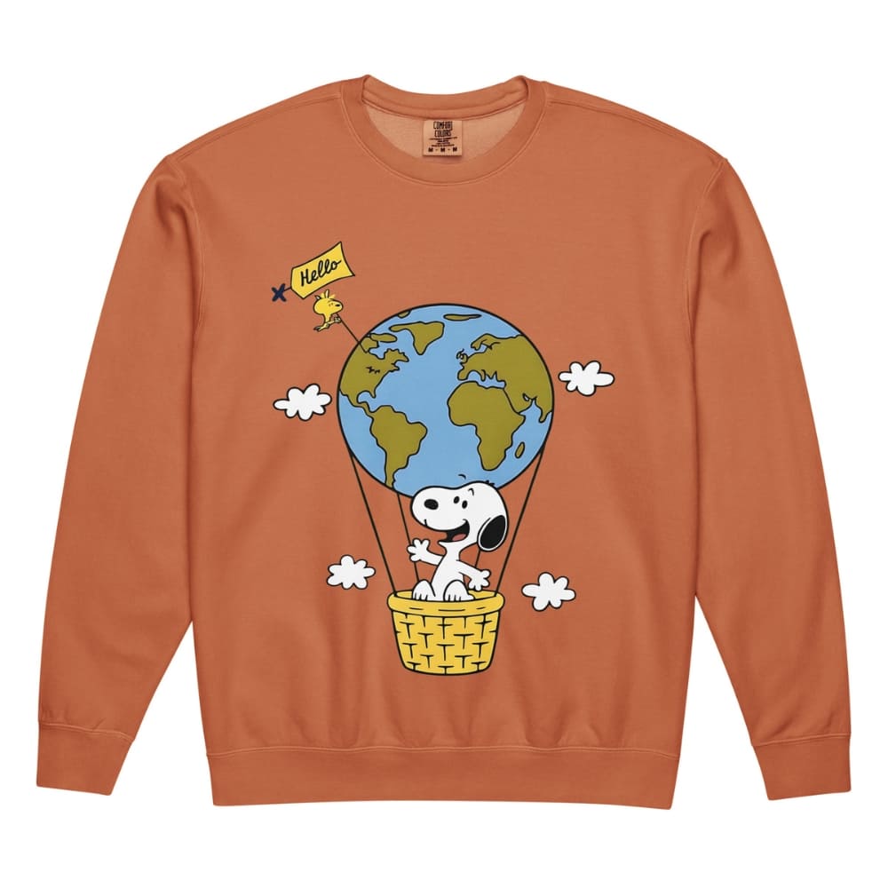 Orange sweatshirt with a cartoon design of a dog in a hot air balloon with the Earth, on a white background.