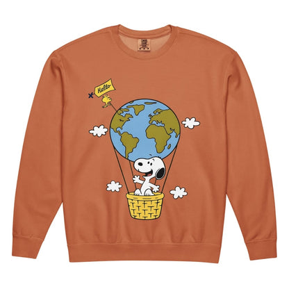 Orange sweatshirt with a cartoon design of a dog in a hot air balloon with the Earth, on a white background.