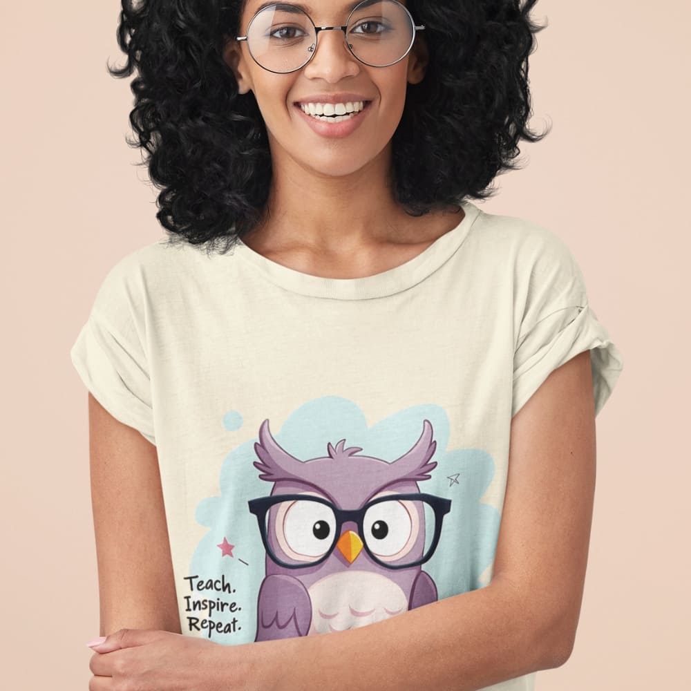 Cute purple owl with glasses sitting on stacked books, with quote "Teach. Inspire. Repeat." – printed on a teacher t-shirt