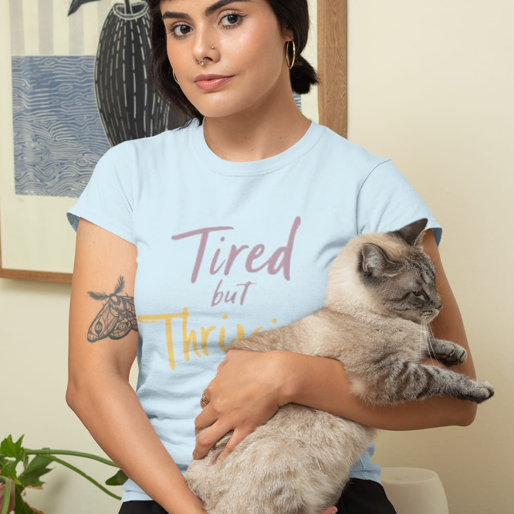 Garment-dyed relaxed fit t-shirt with motivational quote “Tired But Thriving” in modern handwritten script