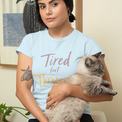 Garment-dyed relaxed fit t-shirt with motivational quote “Tired But Thriving” in modern handwritten script