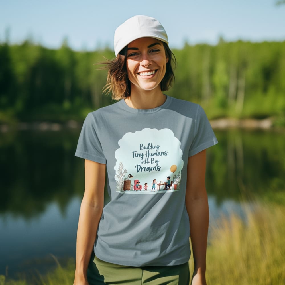 Illustrated t-shirt design with the quote "Building Tiny Humans with Big Dreams" surrounded by a family parenting scene