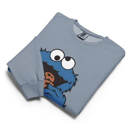Folded blue sweatshirt with a cartoon character design on a white background