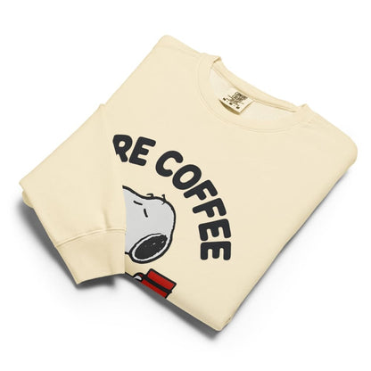 Folded beige sweatshirt with 'RE COFFEE' text and cartoon design on a white background