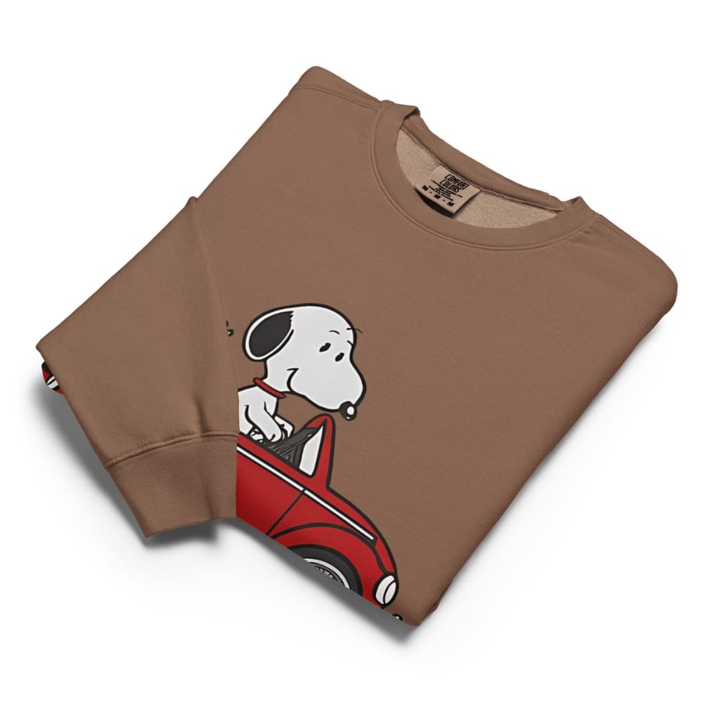Folded brown sweatshirt with a cartoon dog design on a white background
