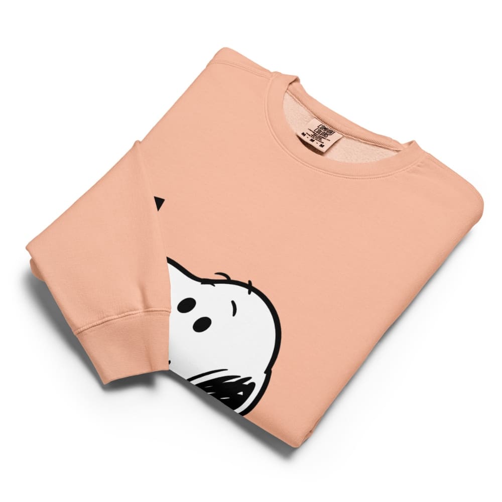 Folded peach-colored sweatshirt with a cartoon ghost design on a white background