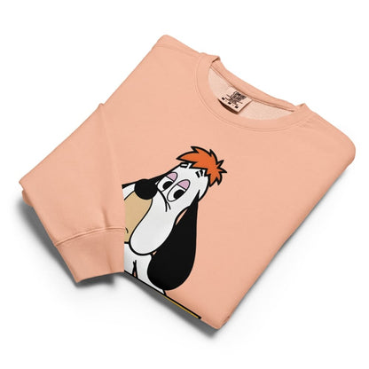 Folded peach-colored sweatshirt with cartoon character design on a white background