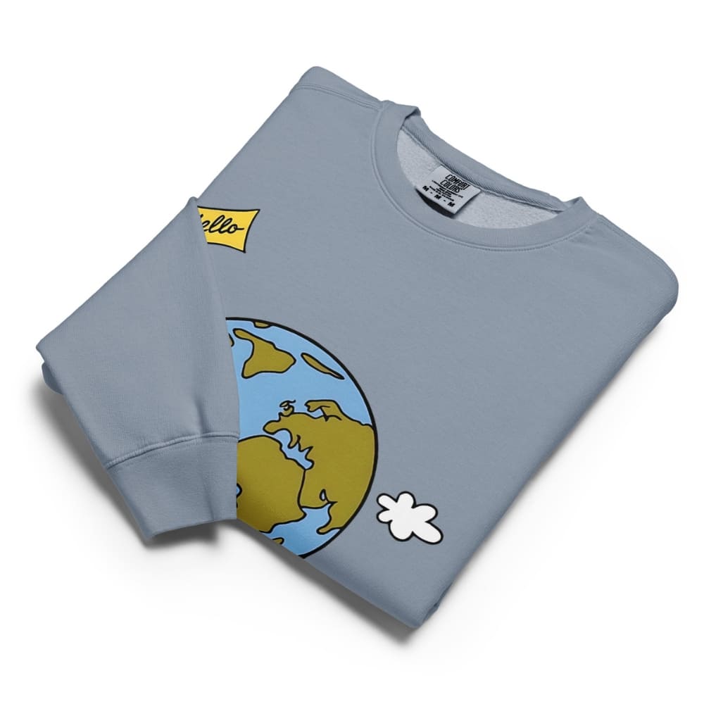 Folded light blue sweatshirt with cartoon design on a white background