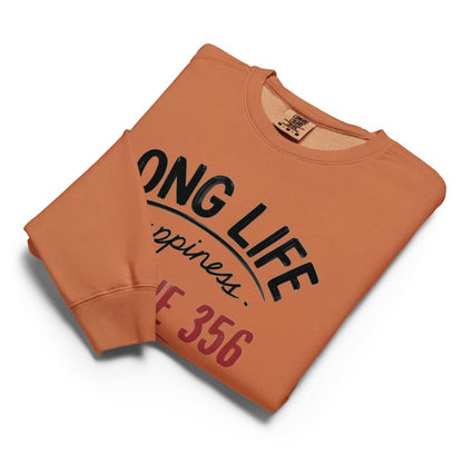 Folded orange sweatshirt with text on a white background