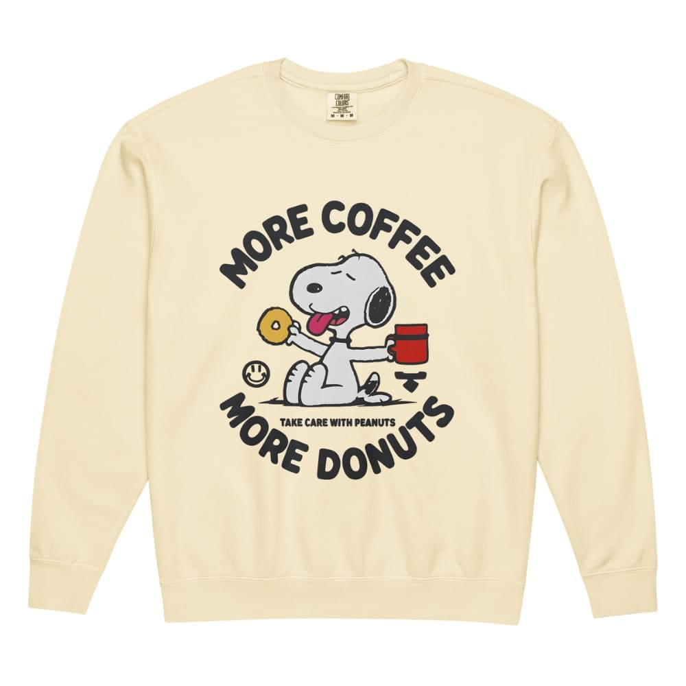 Beige sweatshirt with Snoopy graphic and text 'More Coffee, More Donuts' on a white background