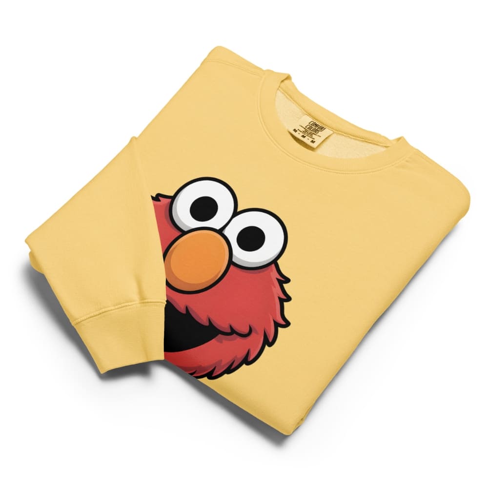 Yellow sweatshirt with a cartoon character face on a white background