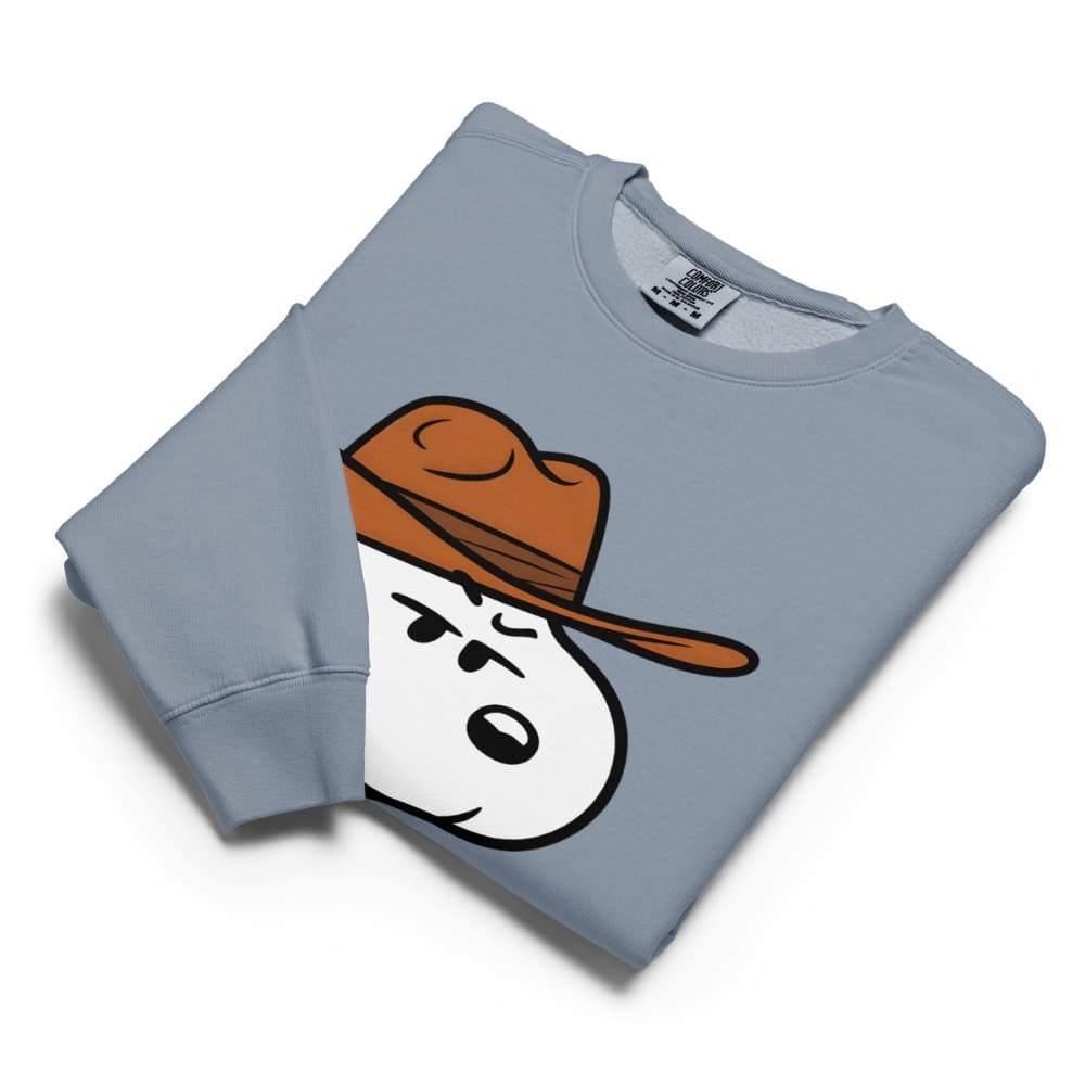 Folded light blue sweatshirt with a cartoon snowman design wearing a brown hat on a white background.