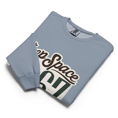 Folded light blue sweatshirt with 'Keep Space 1967' graphic on a white background