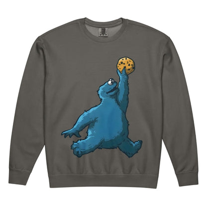 Gray sweatshirt with a blue creature holding a cookie design on a white background
