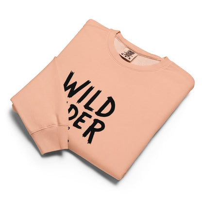 Peach-colored sweatshirt with 'Wild Rider' text on a white background