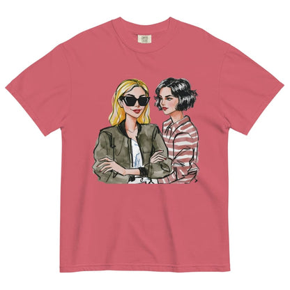 Pink t-shirt with graphic of two women on a white background
