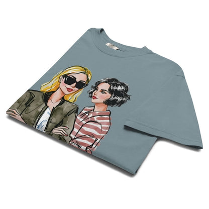 Ice-blue t-shirt with graphic of two women on a white background