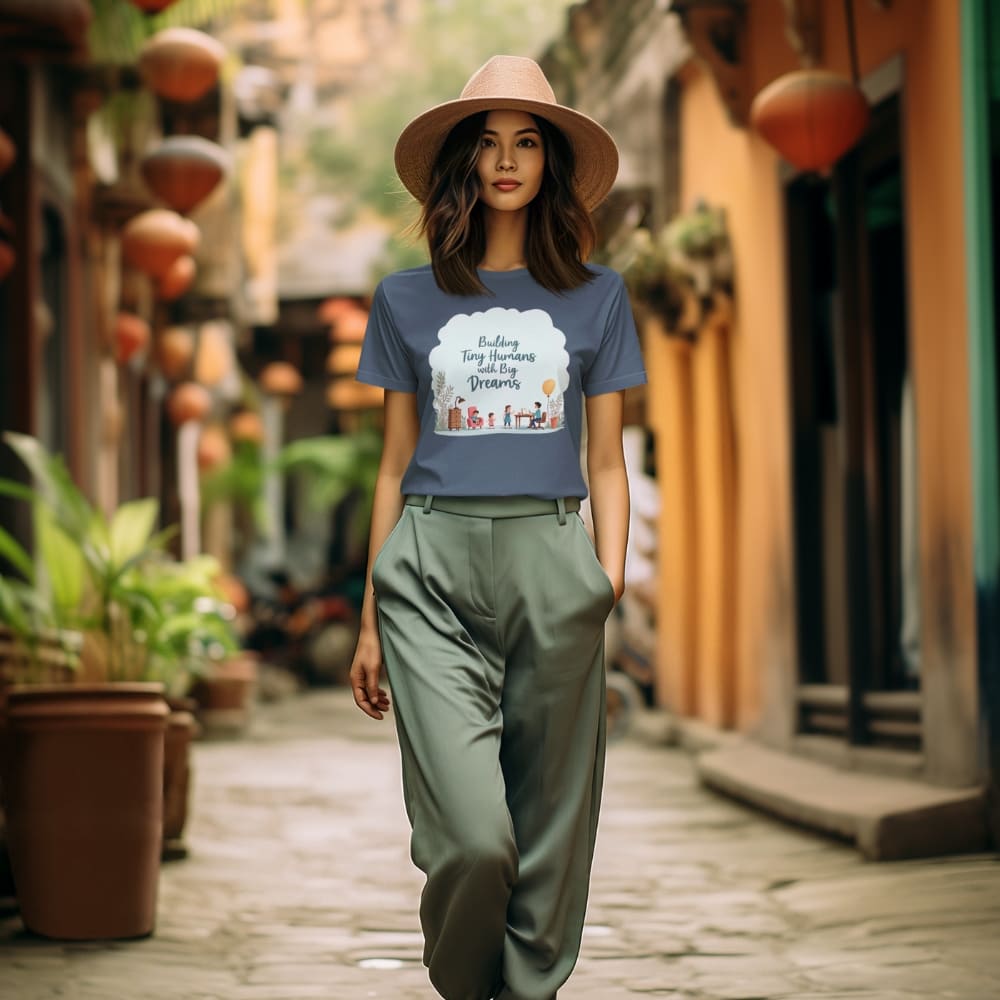 Illustrated t-shirt design with the quote "Building Tiny Humans with Big Dreams" surrounded by a family parenting scene