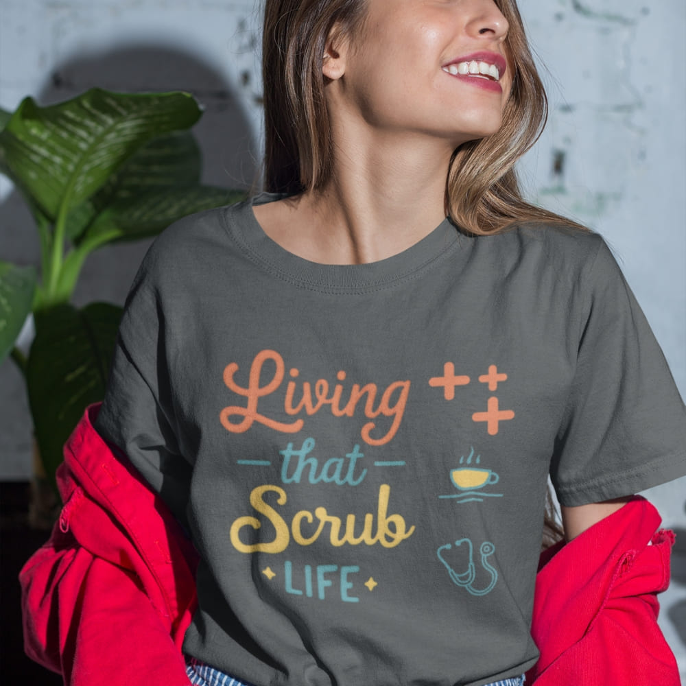 “Living That Scrub Life” colorful text printed on a garment-dyed cotton t-shirt for nurses and healthcare professionals
