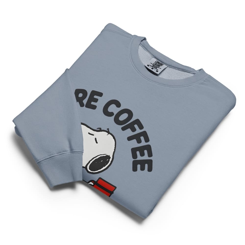 Folded light blue sweatshirt with 'RE COFFEE' text and cartoon character on a white background
