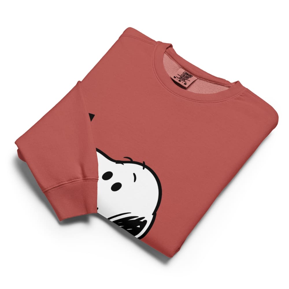 Folded red sweatshirt with a cartoon ghost design on a white background