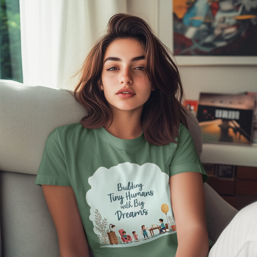 Illustrated t-shirt design with the quote "Building Tiny Humans with Big Dreams" surrounded by a family parenting scene