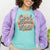 Graphic t-shirt with text “Cool Moms Raise Cool Kids” in bold vintage font – fun parenting design on soft garment-dyed cotton tee