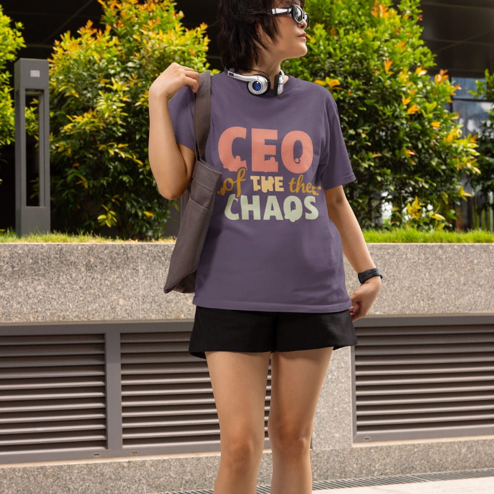 CEO of the Chaos” printed on a heavyweight cotton t-shirt in soft pastel ink, laid flat with a minimal lifestyle background.