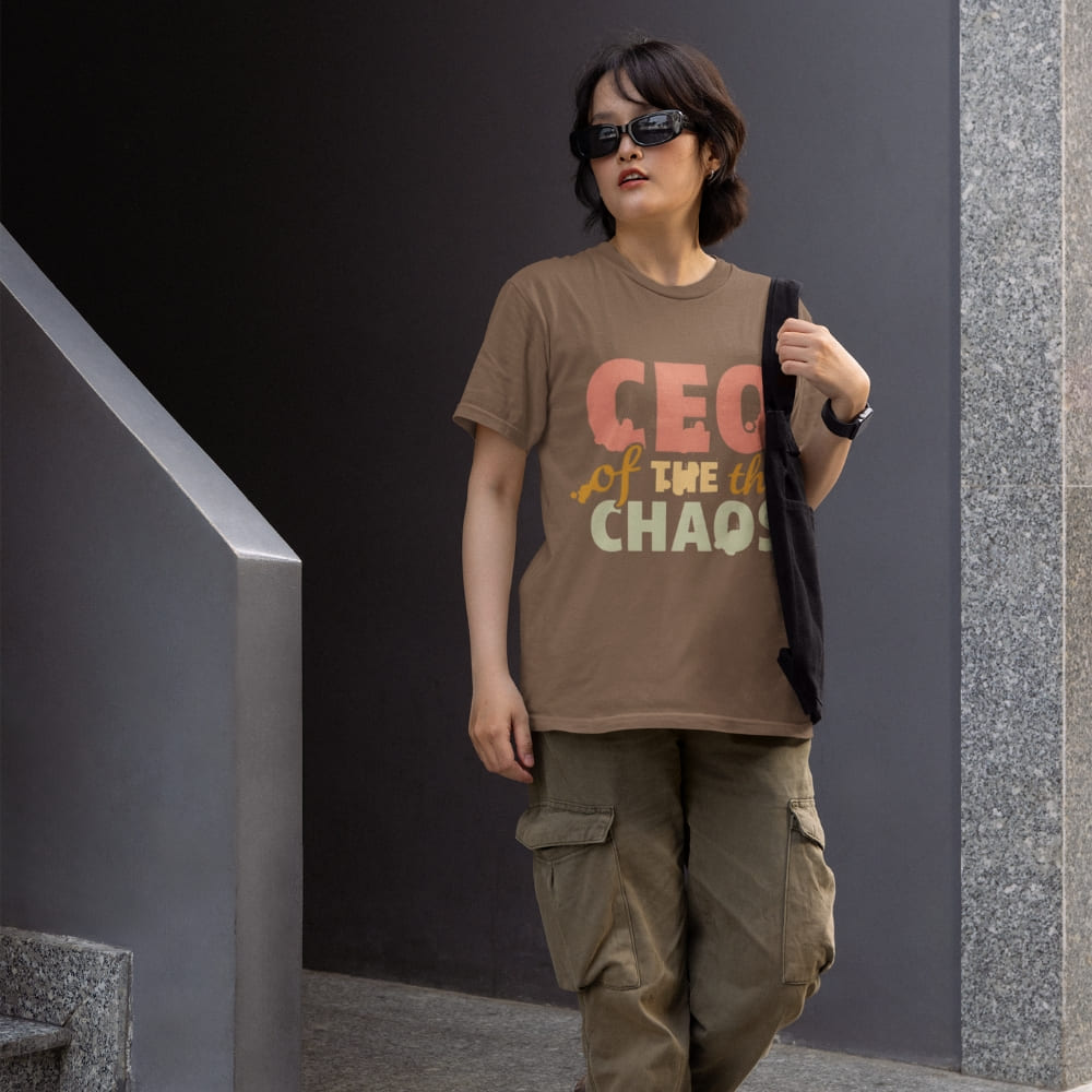 CEO of the Chaos” printed on a heavyweight cotton t-shirt in soft pastel ink, laid flat with a minimal lifestyle background.