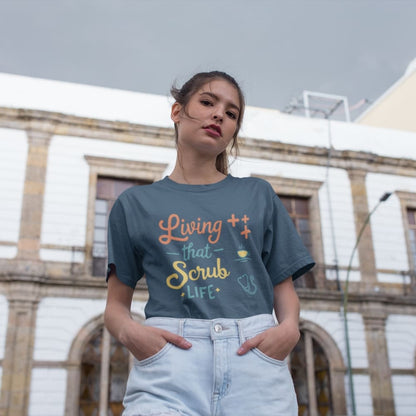 “Living That Scrub Life” colorful text printed on a garment-dyed cotton t-shirt for nurses and healthcare professionals