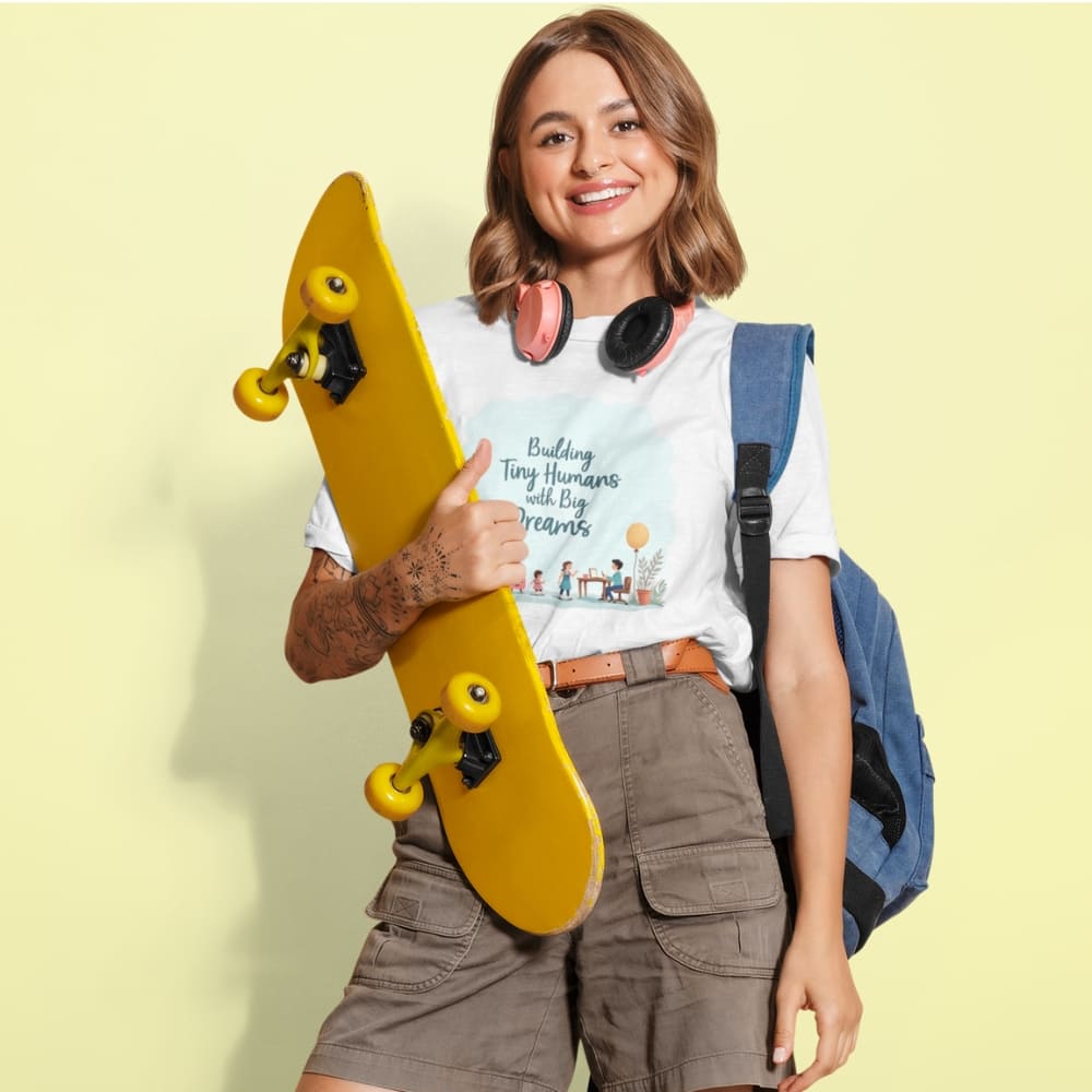 Illustrated t-shirt design with the quote "Building Tiny Humans with Big Dreams" surrounded by a family parenting scene