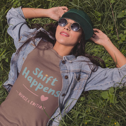 “Shift Happens – Nurse Edition” pastel text design printed on a thick garment-dyed cotton t-shirt, perfect for nurses and healthcare professionals with a sense of humor.